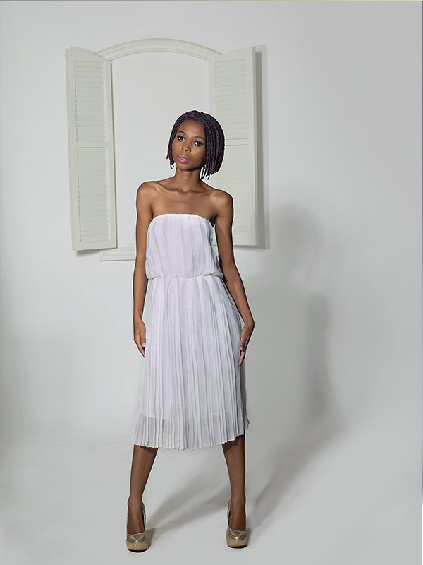 petite black female model in white dress